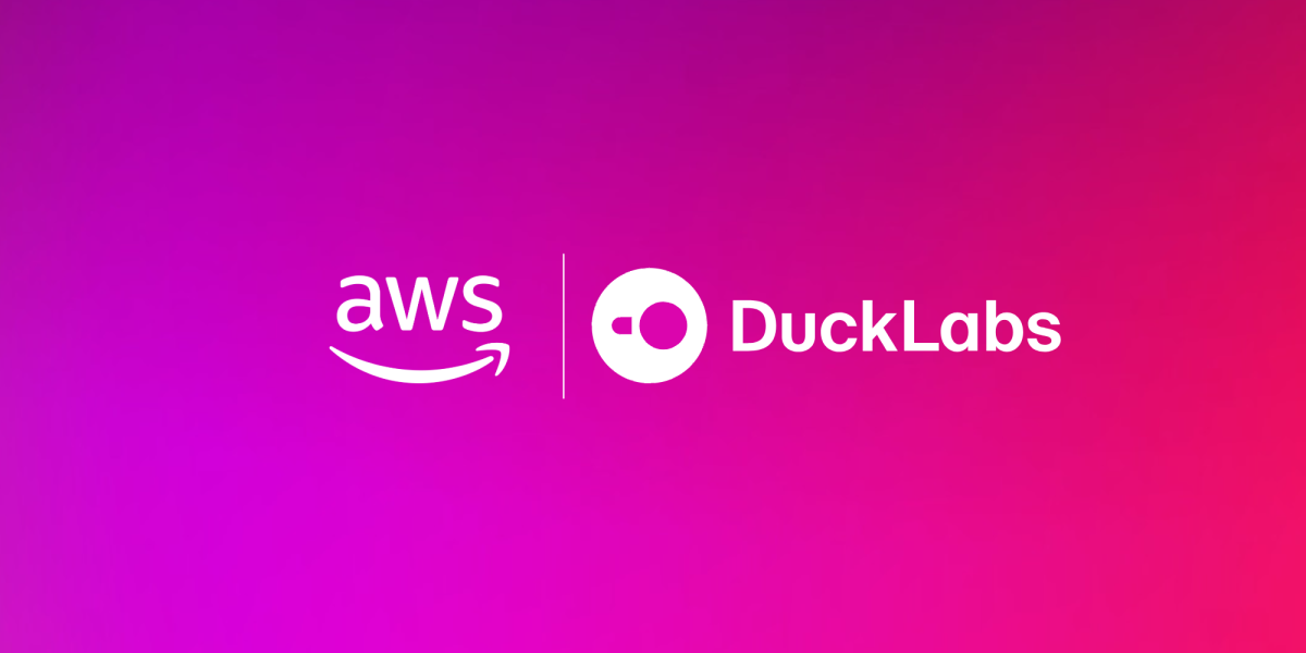 Official Amazon announcement graphic for the acquisition, showing the AWS logo and the DuckLabs logo side by side in white on a magenta and pink gradient background.