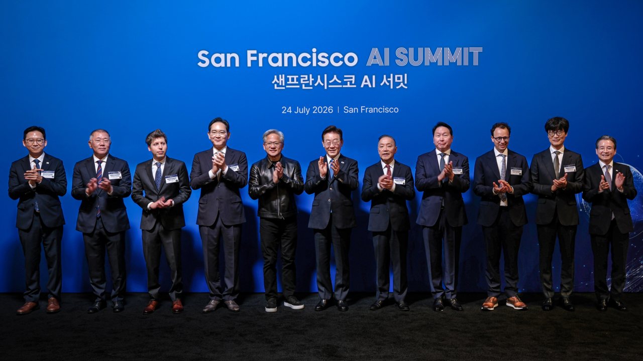 Official San Francisco AI Summit photograph dated 24 July 2026 showing eleven executives and officials applauding on stage in front of a blue backdrop.
