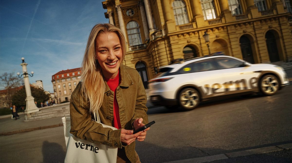 A Verne-branded white robotaxi driving past the Croatian National Theatre in Zagreb, from the Verne press material for Europe first commercial robotaxi service, which runs Pony.ai autonomous driving technology.