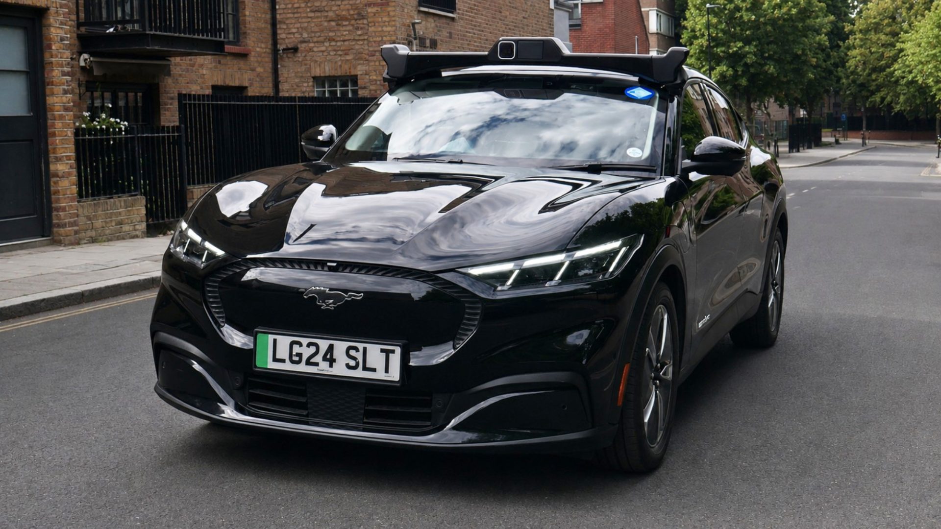 A Wayve autonomous Ford Mustang Mach-E in Uber livery on a London street, from the Wayve press release announcing that Transport for London granted private hire vehicle licences to its self-driving cars.